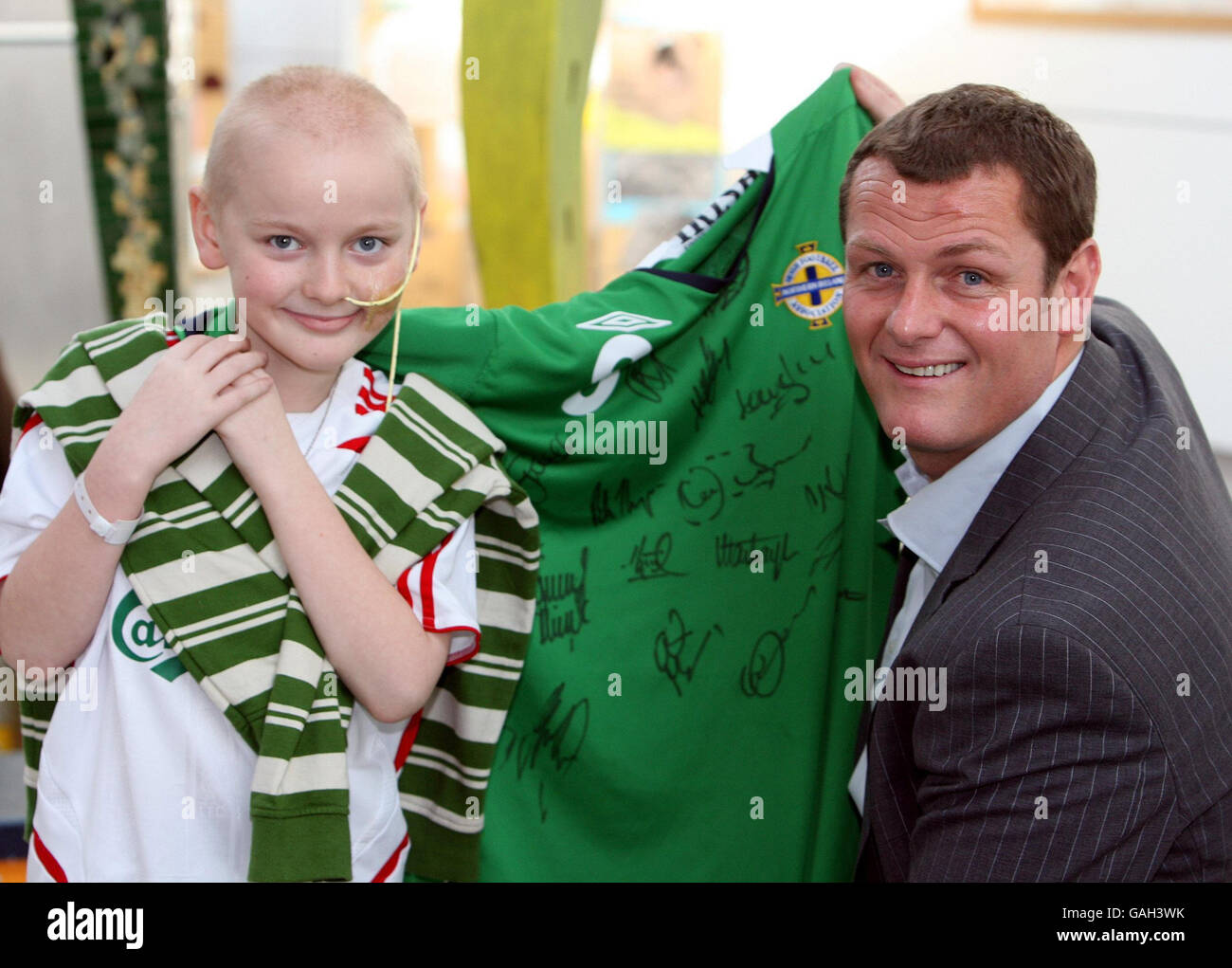 Ipswich Town manager Jim Magilton presents eight-year-old Conor Patterson from Enniskillen Co Fermanagh, with a signed Northern Ireland football shirt at the Royal Victoria hospital, Belfast. Stock Photo