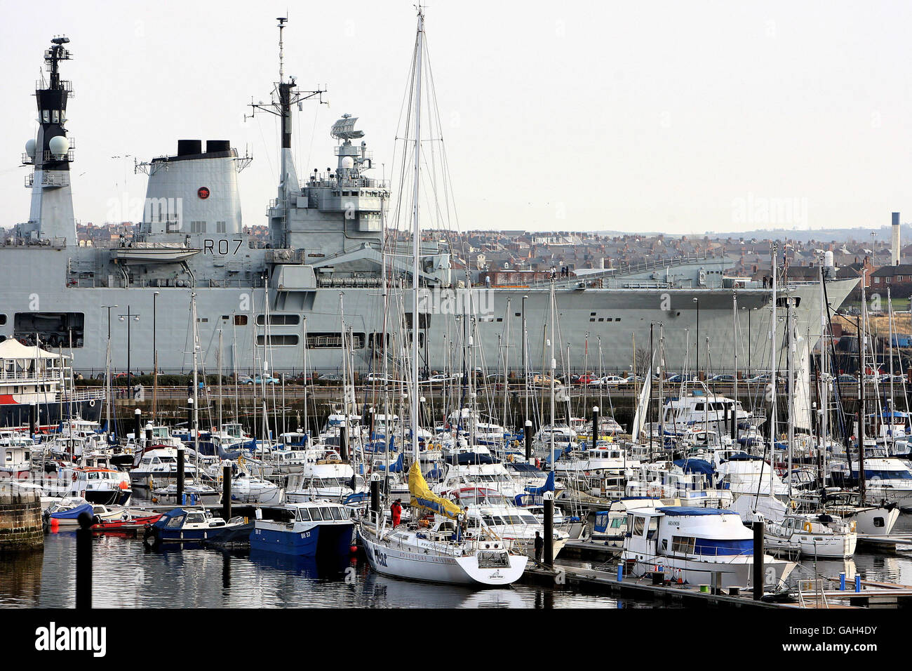 The HMS Ark Royal towers above the smaller yachts at Marine Wharf in North Shields today whilst on a visit to the North east. Stock Photo