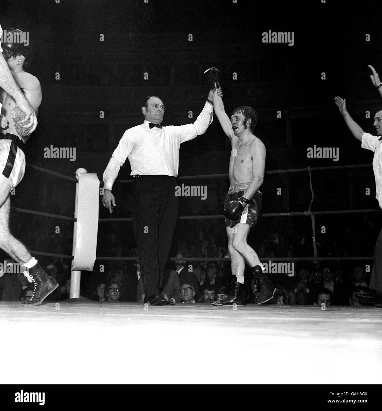 (LR) Referee Harry Gibbs raises the hand of the victorious Alan Rudkin