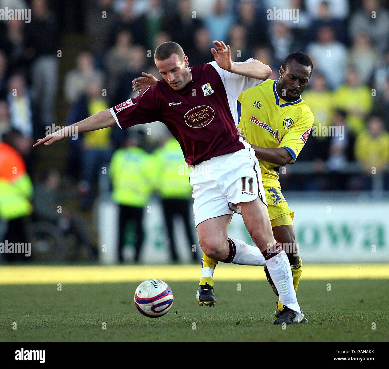 Northampton's Andy Holt (left) in action with Leeds United's Darren Kenton during the League One match at Sixfields Stadium, Northampton. Stock Photo