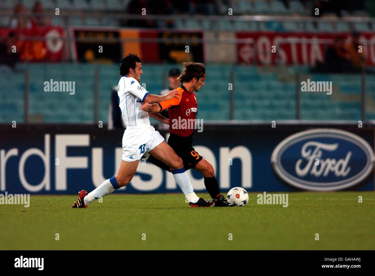 (L-R) RC Genk's Akran Roumani and Roma's Vincenzo Montella battle for the ball Stock Photo