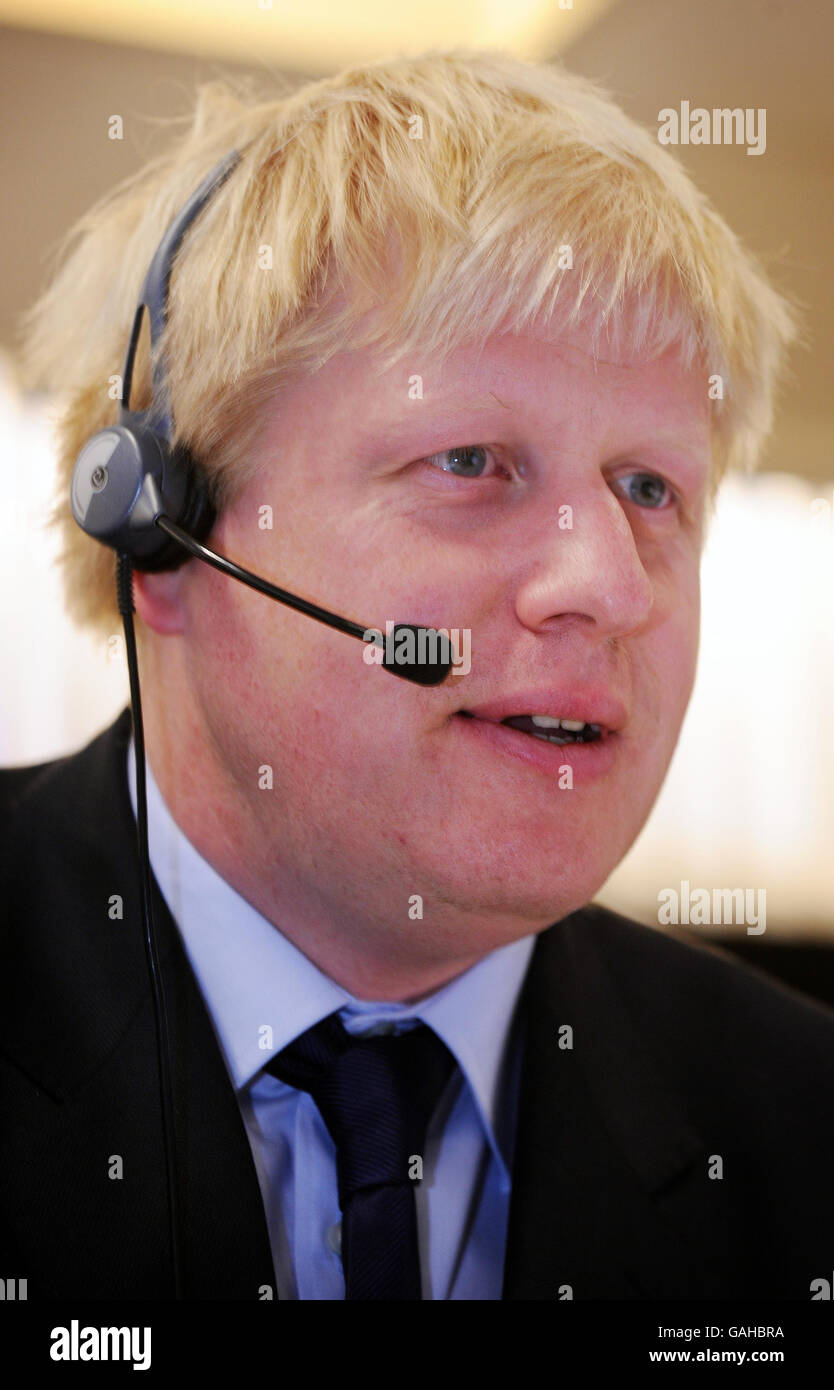 Boris Johnson MP, Conservative candidate for London Mayor in the  forthcoming Mayoral election on May 1st, wearing headphones on a visit to  the British Transport Police London headquaters today Stock Photo -