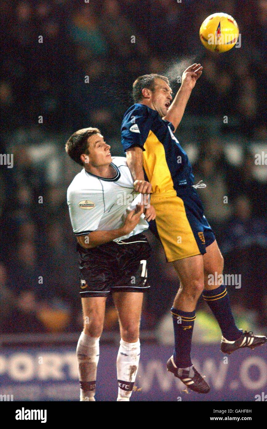 Wimbledon's Neil Shipperley (r) wins a header above Derby County's Paul ...