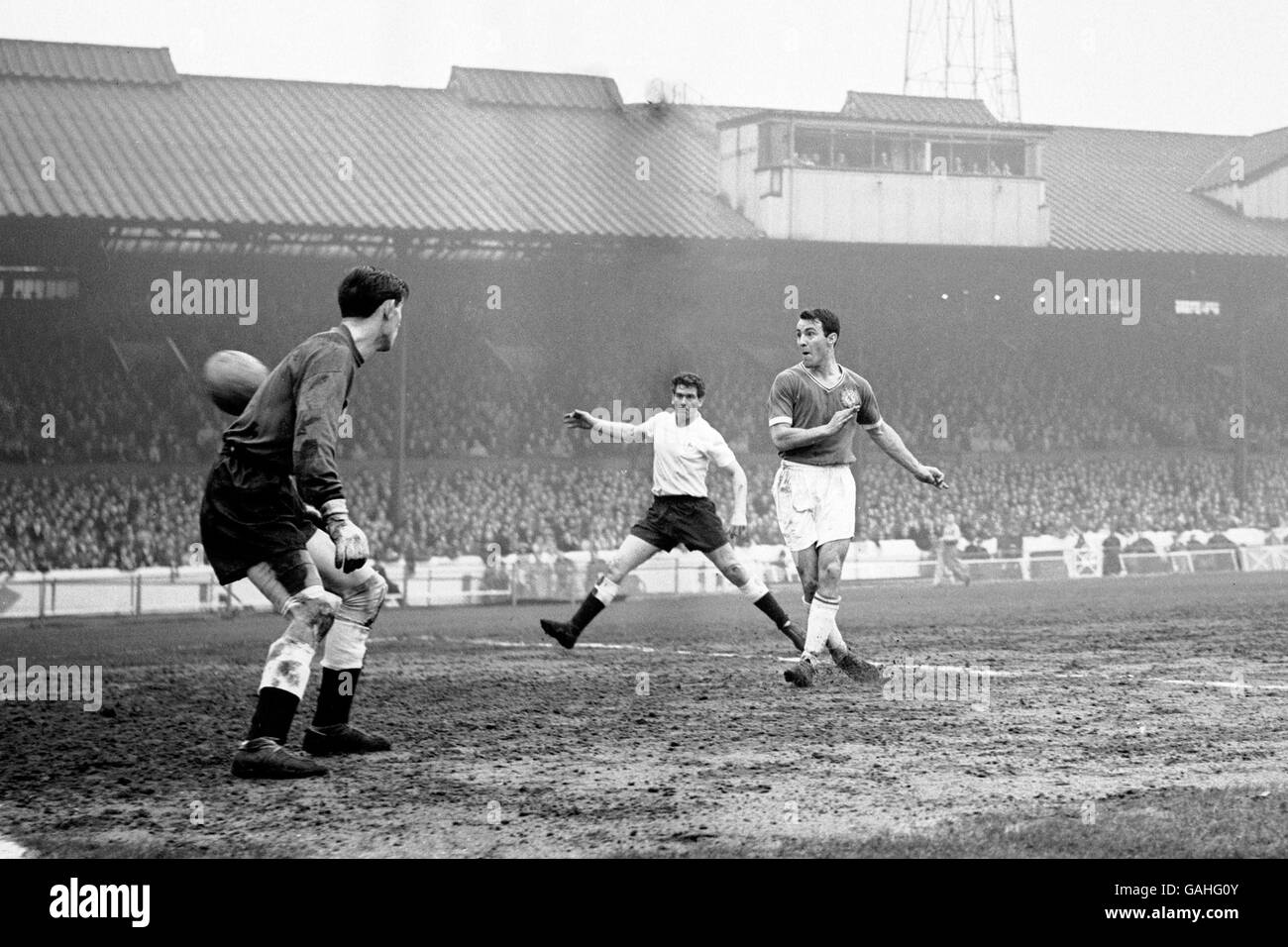 Soccer - Football League Division One - Chelsea v Tottenham Hotspur. Chelsea's Jimmy Greaves (r) flips the ball into the empty net, watched by Tottenham Hotspur's Ron Henry (c) and goalkeeper Bill Brown (l) Stock Photo