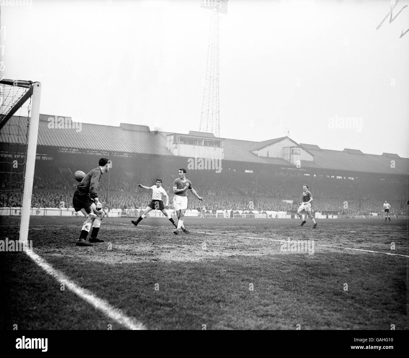 Soccer - Football League Division One - Chelsea v Tottenham Hotspur. Chelsea's Jimmy Greaves (r) flips the ball into the empty net, watched by Tottenham Hotspur's Ron Henry (c) and goalkeeper Bill Brown (l) Stock Photo