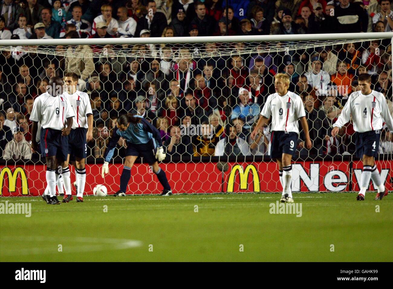 England's goalkeeper David Seaman picks the ball out the net after Macedonia scored their first goal as Sol Campbell, Jonathan Woodgate and Alan Smith walk away dejected Stock Photo
