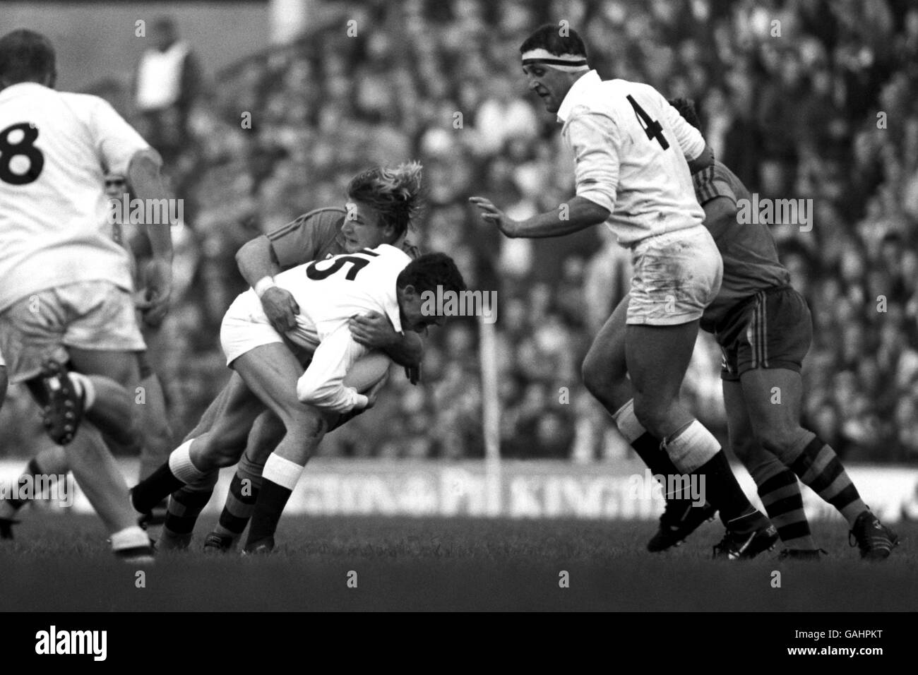 England's Jonathan Webb (15) is tackled by Australia's Michael Lynagh (c), watched by teammate Wade Dooley (r) Stock Photo