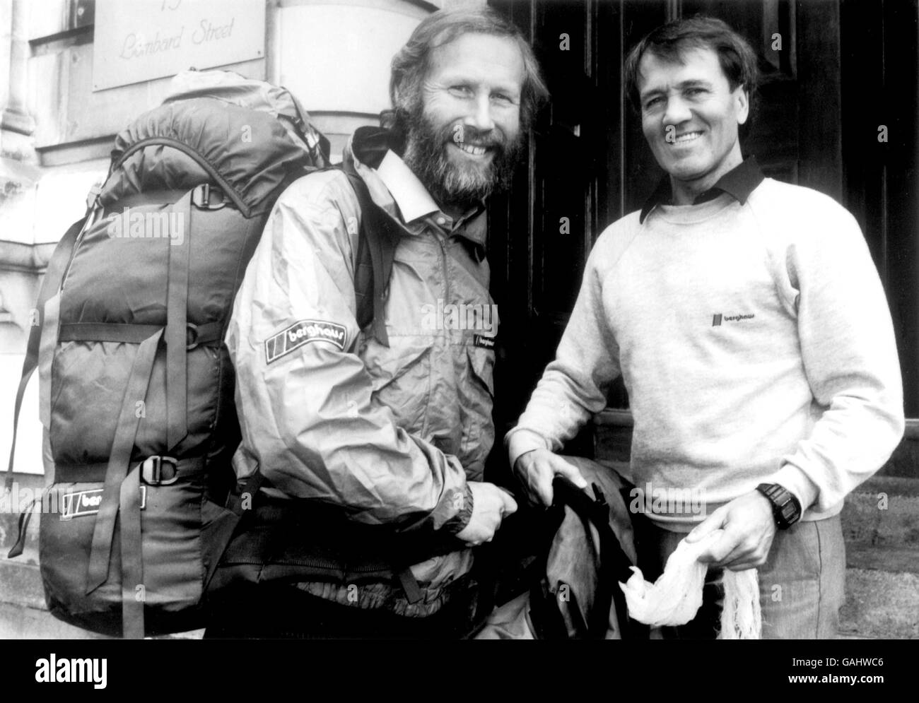 (L-R) Chris Bonington meets up with Berghaus Managing Director Peter Lockey on his return to Britain from Mount Everest, where he reached the summit via the South Col route on 21st April 1985 Stock Photo