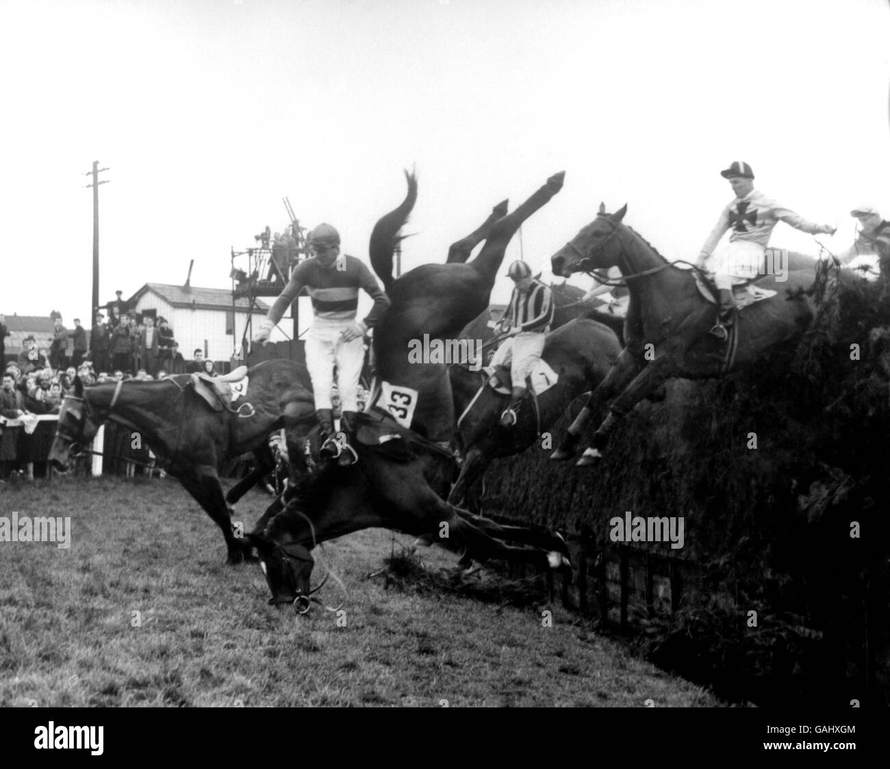 Horse Racing - The Grand National - Aintree. A gruesome sight at Becher's Brook the first time round as Kingstel (33), George Slack up, takes a nose dive into the turf. Stock Photo
