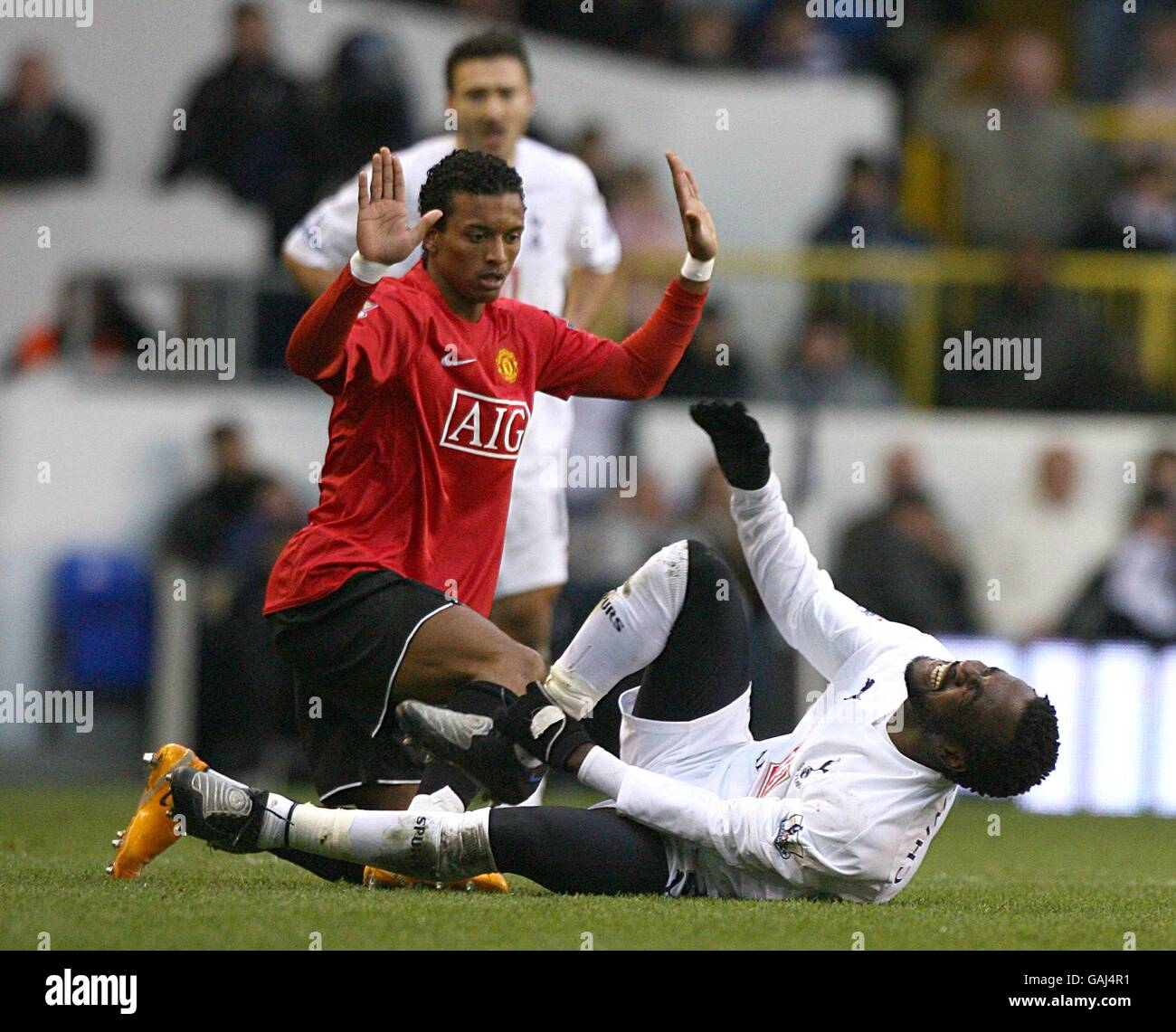 Manchester United's Luis Nani holds his hands up and apologises following his challenge on Tottenham Hotspur's Pascal Chimbonda Stock Photo