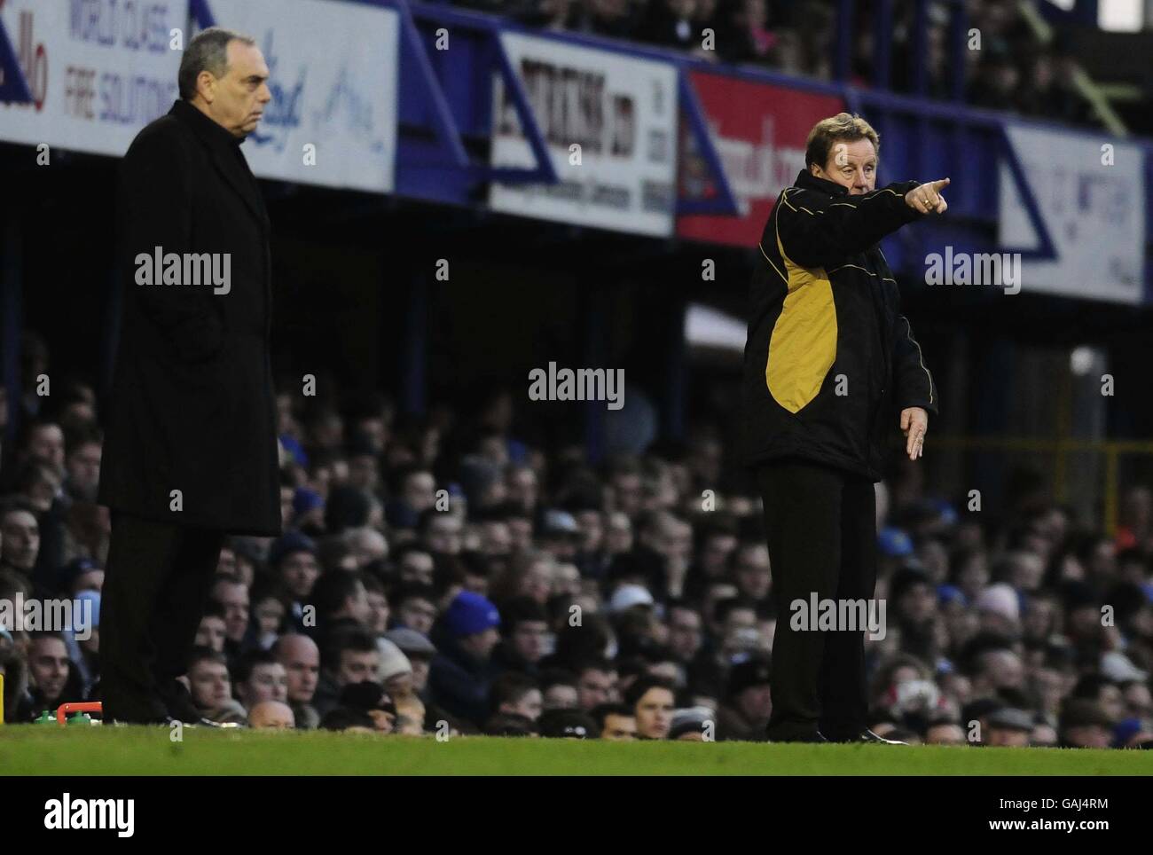 Chelsea's Avram Grant and Portsmouth's Harry Redknapp watch during the Barclay's Premier League match at Fratton Park, Portsmouth. Stock Photo