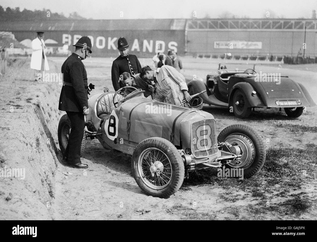Motor Sport - Campbell's Trophy Race - Brooklands. Earl Howe's ERA R8B/C car being inspected by police after an accident at Brooklands that did serious damage to both the R8B and Howe. Stock Photo