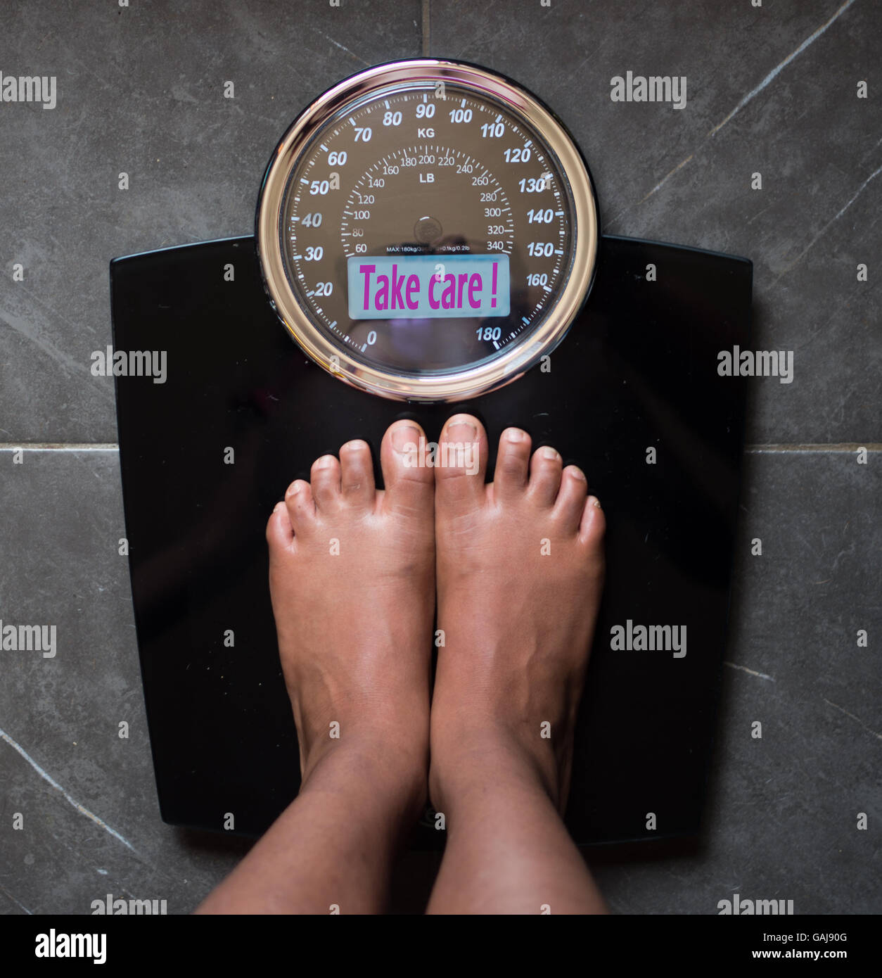 the bathroom scales that speaks to you and tells you the truth by writing it on the screen: you smile! Stock Photo