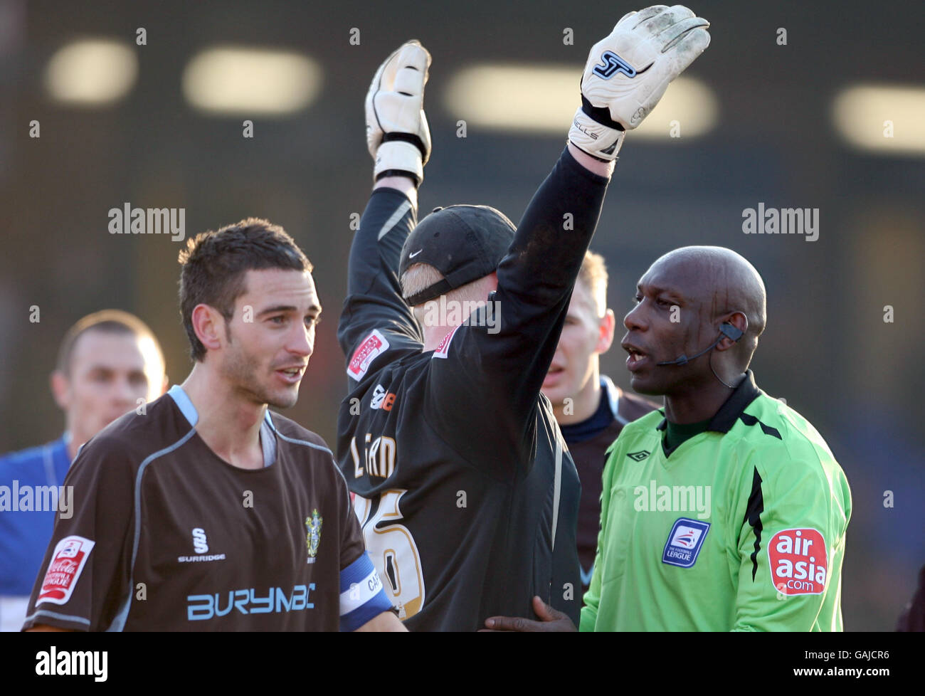Match referee Uriah Rennie gives Stockport County goalkeeper Conrad