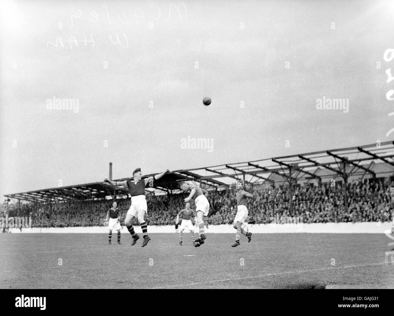 West Ham United's Archie Macaulay (l) flicks the ball high into the air from a cross Stock Photo