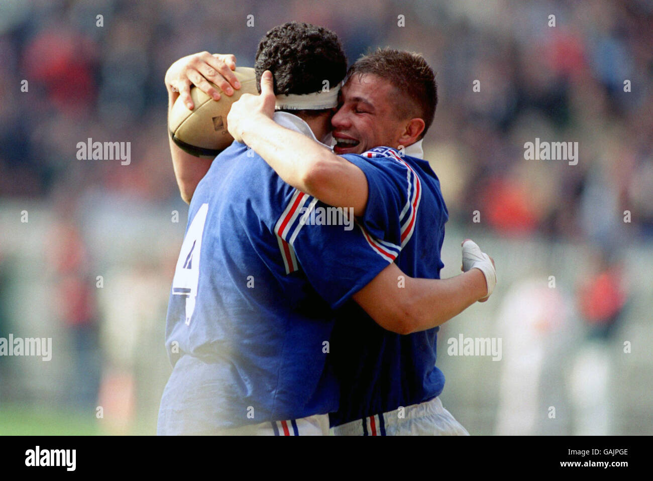 FIVE NATIONS RUGBY.. FRANCE'S PHILIPPE BENETTON [RIGHT] CELEBRATES TRY WITH TEAMATE ABDELATIF BENAZZI,OVER WALES. Stock Photo