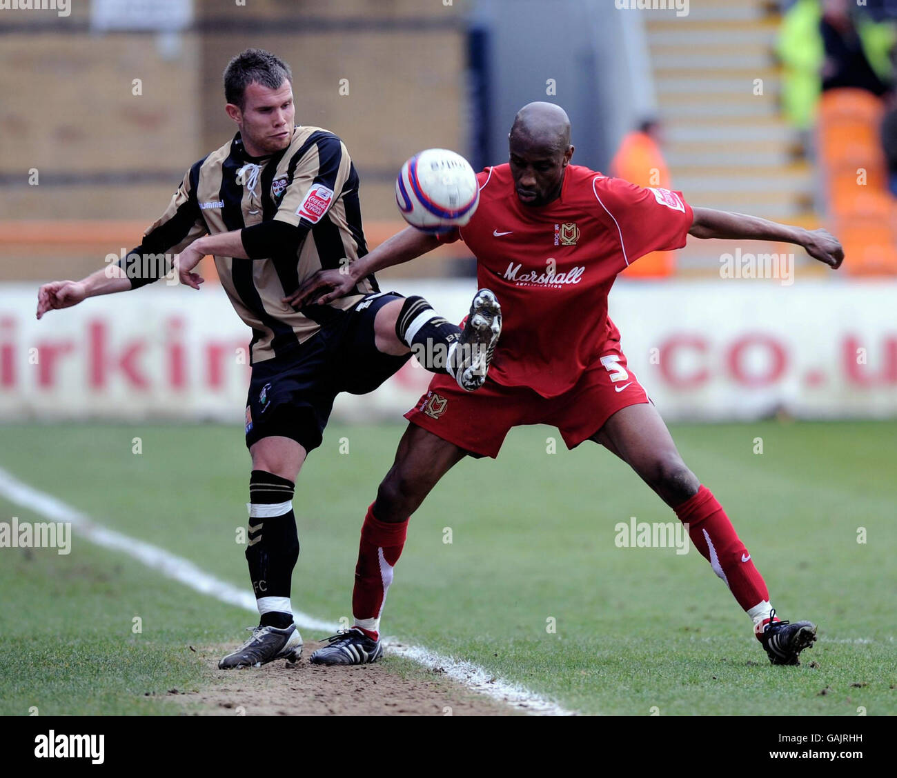 Barnet's Adam Birchall and Milton Keynes Dons' Drissa Diallo battle for the ball during the Coca-Cola Football League Two match at the Underhill Stadium, Barnet. Stock Photo