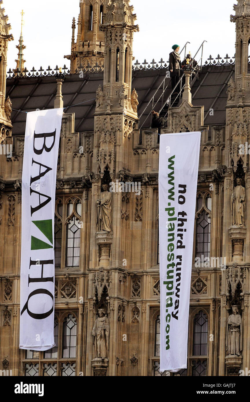 Protesters hang banners off the roof of the Houses of Parliament demonstrating against expanding Heathrow airport. Stock Photo