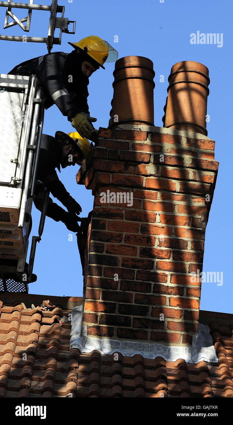Fire crews in Hull tackle one of numerous collapsed chimney stacks across the City today following the earthquake. Stock Photo