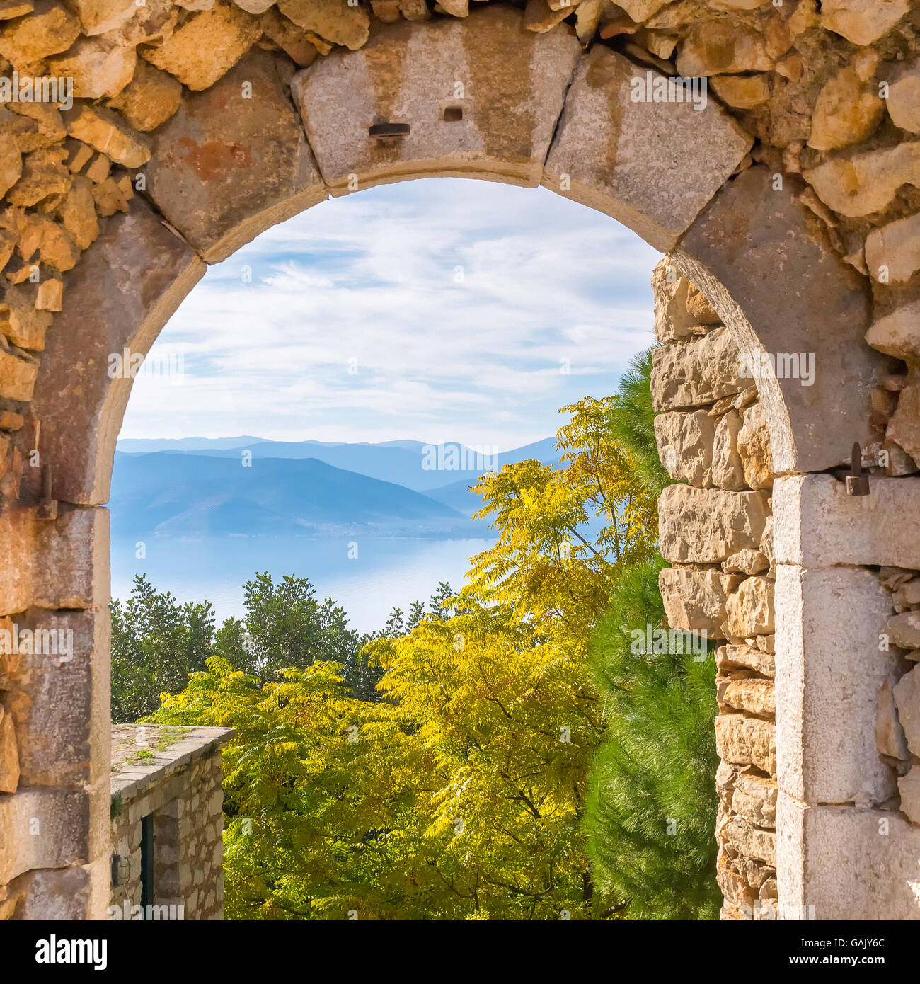 Beautiful landscape at Nafplio in Greece through the old arched stoney doorway of Palamidi castle. Stock Photo