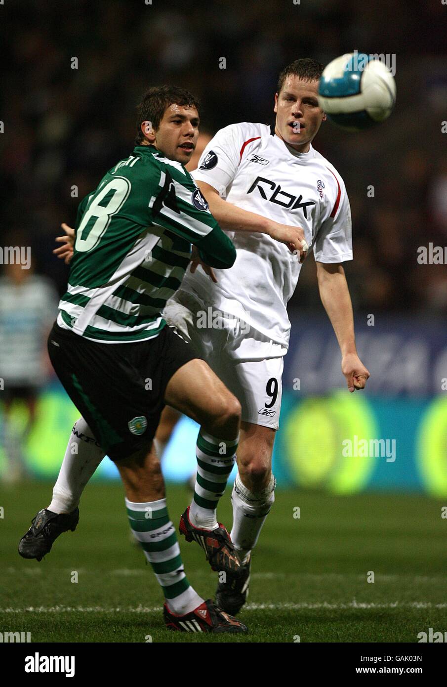 Bolton Wanderers' Heidar Helguson and Sporting Lisbon's Leandro Grimi (left) battle for the ball Stock Photo