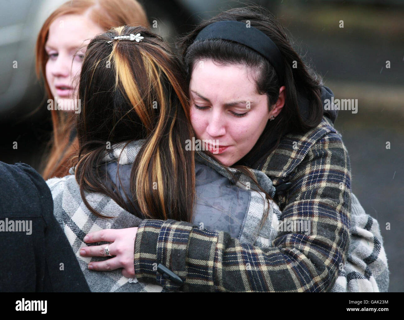 Friends comfort each other during the funeral of 16-year-old teenager Nicola Murray, who died in a school bus accident, at the Church of Assumption in Tullyallen. Stock Photo