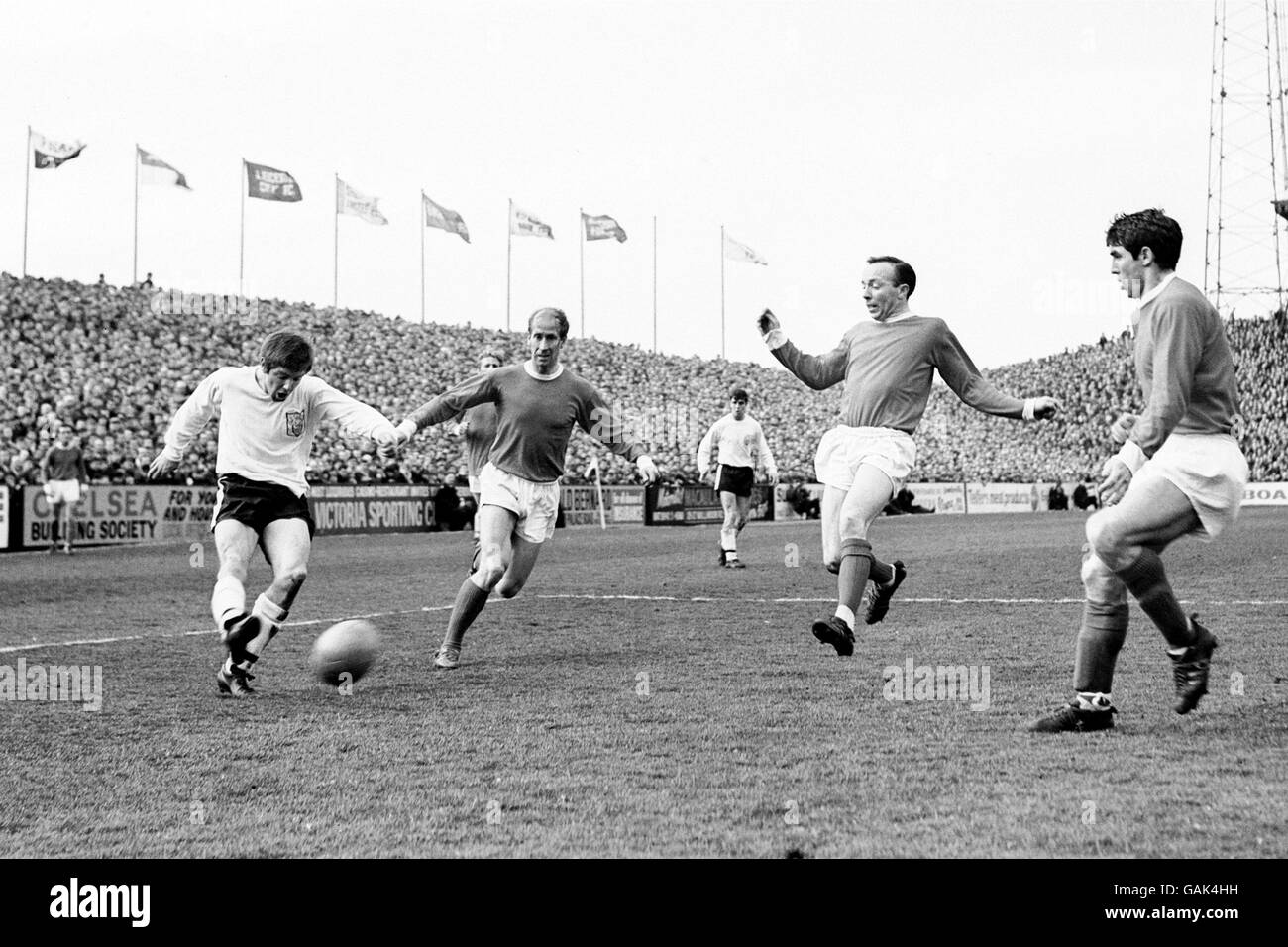 (L-R) Fulham's Les Barrett crosses the ball as Manchester United's Bobby Charlton, Nobby Stiles and Tony Dunne attempt to block it Stock Photo
