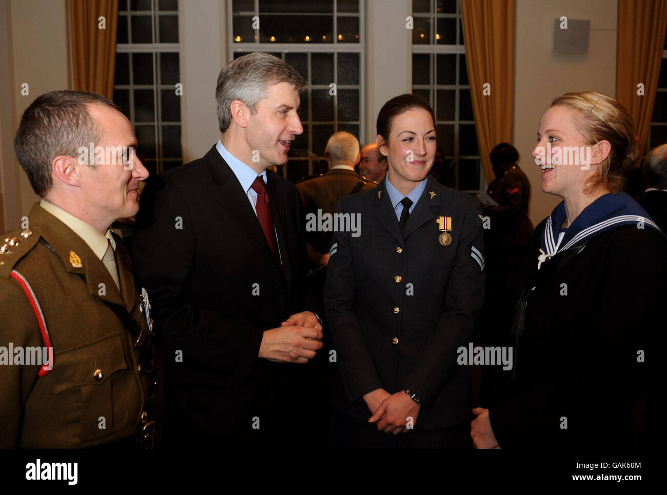 Derek Twigg (2nd left) the under Secretary of State of Defence, talks to Army Cpt David Lewis from Portsmouth, RAF Cpl Sarah Matchett from Liverpool, and Navy nurse Leanne Parry (left to right) from Birmingham, at the Royal College of Nursing HQ in central London, for a reception to honour the work of military nurses work in Iraq and Afghanistan, this evening. Stock Photo