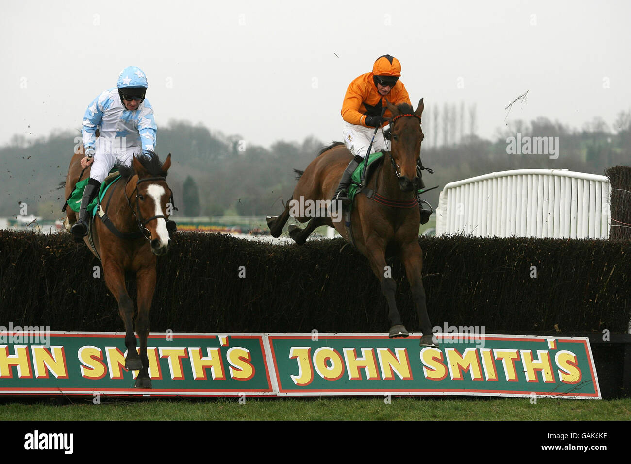 The Real Deal (right in orange) with jockey Darl Jacob on their way to victory from Richard McGrath on Stagecoach Opal (left) in the Ian Hutchinson Memorial Challenge Cup Handicap Steeple Chase. at Uttoxeter Racecourse. Stock Photo