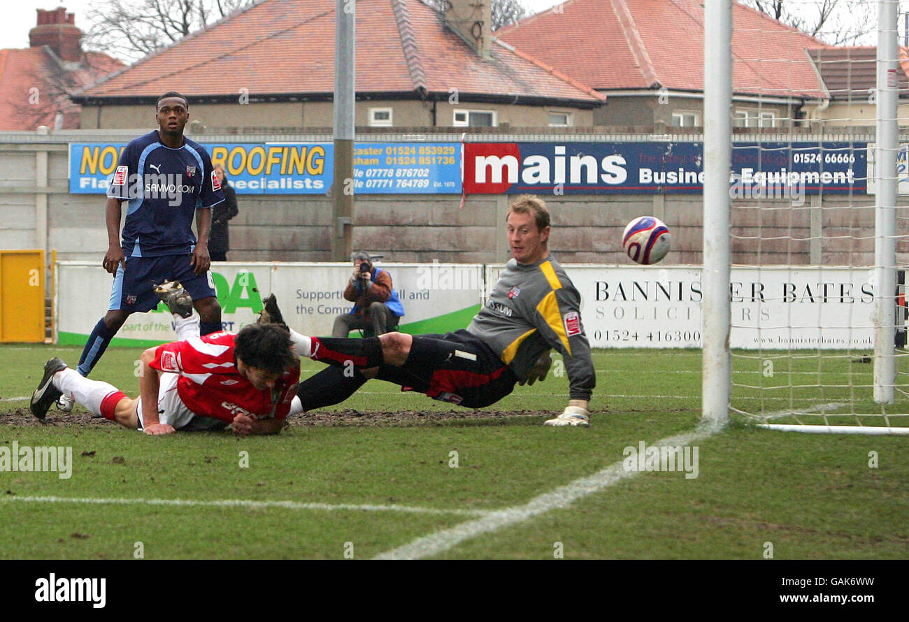 Morecambe's Stuart Drummond scores during the Coca-Cola League Two match at Christie Park, Morecambe. Stock Photo