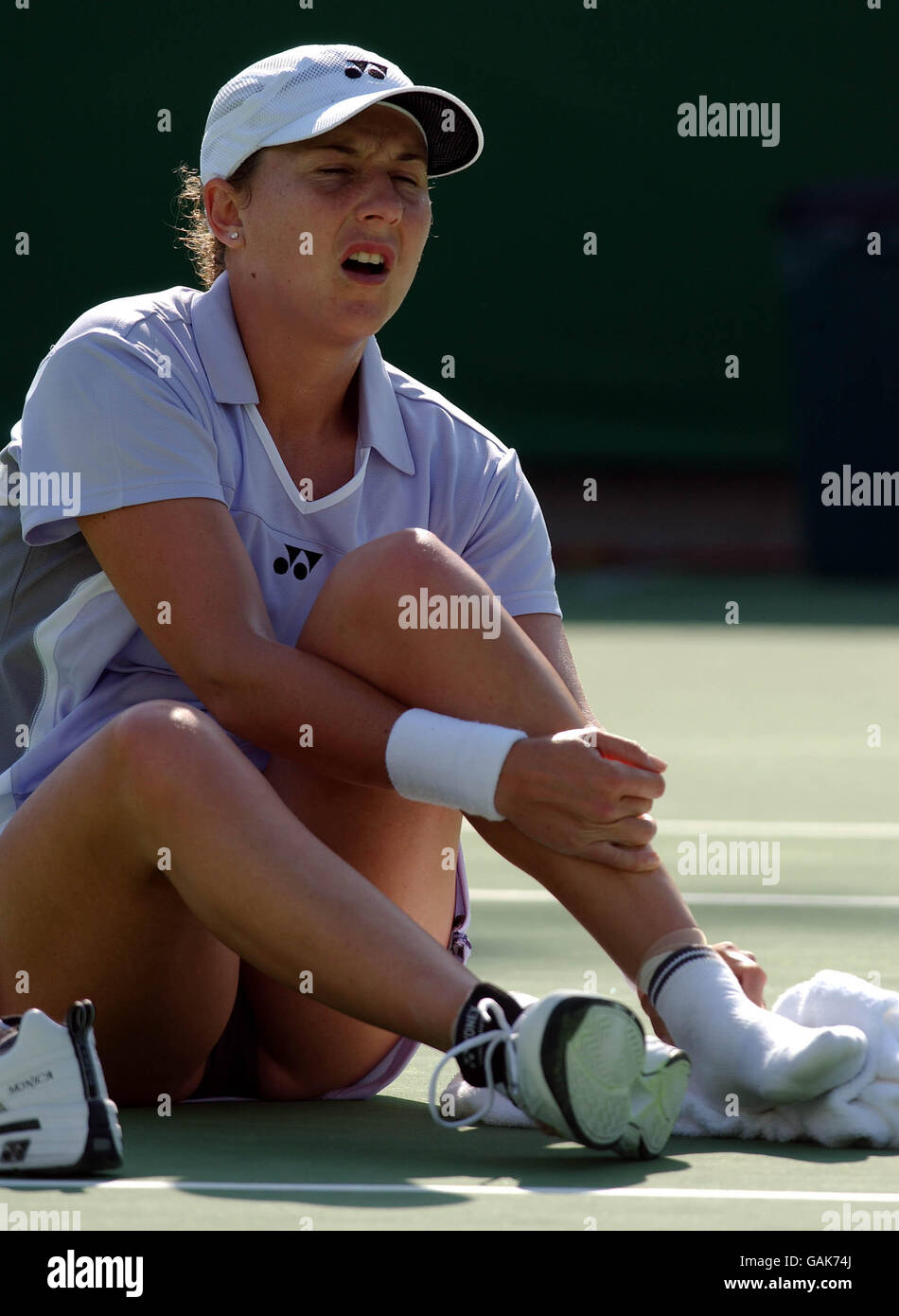 Monica Seles in pain holds her left ankle after stumbling while making a return against Klara Koukalova (CZE). Stock Photo
