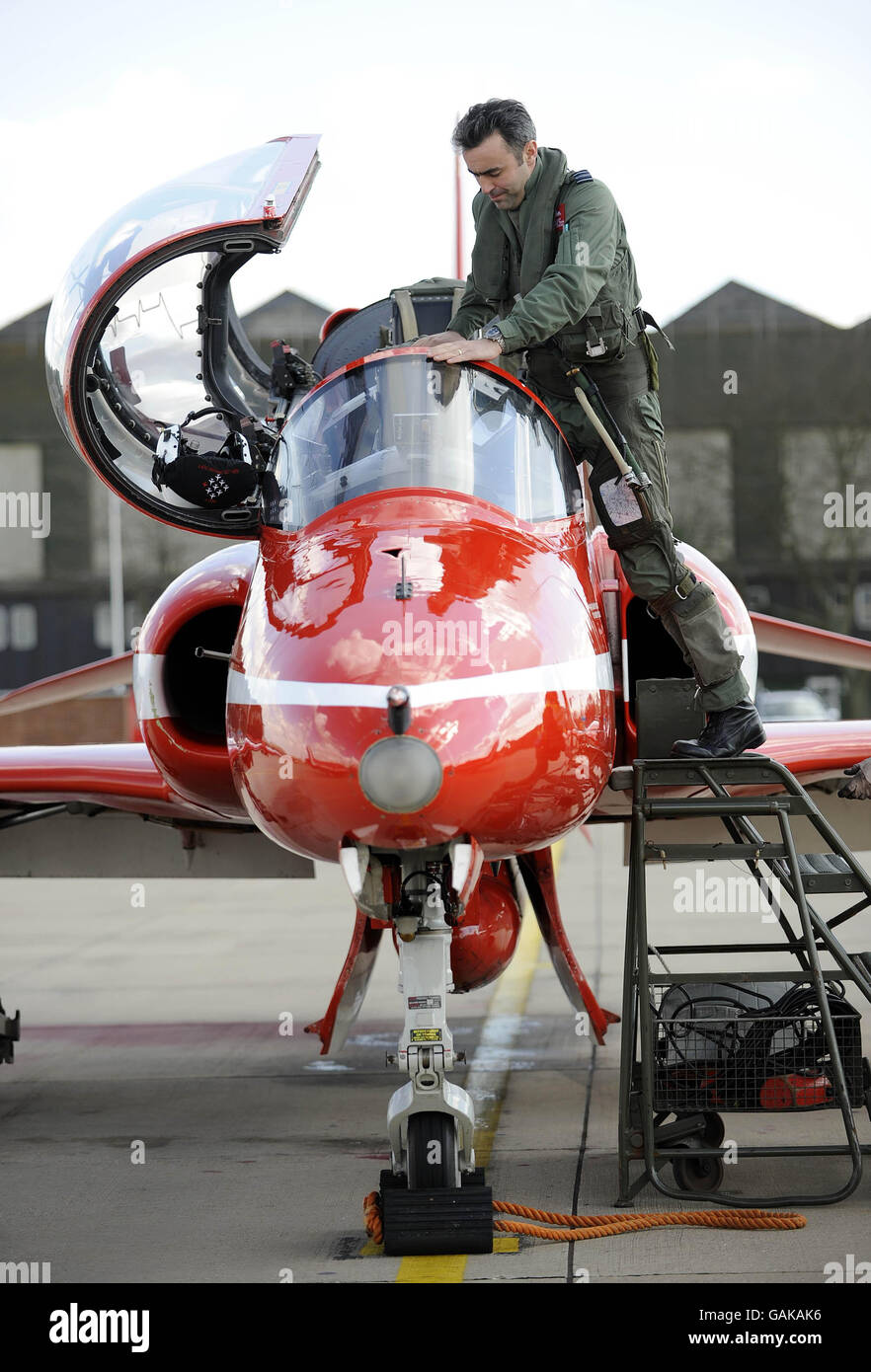Photo. Red Arrows pilot Squadron Leader Graham Duff (Red 4) climbs inside  his aircraft as the team perform their first 2008 display practice in the  skies over their home base of RAF