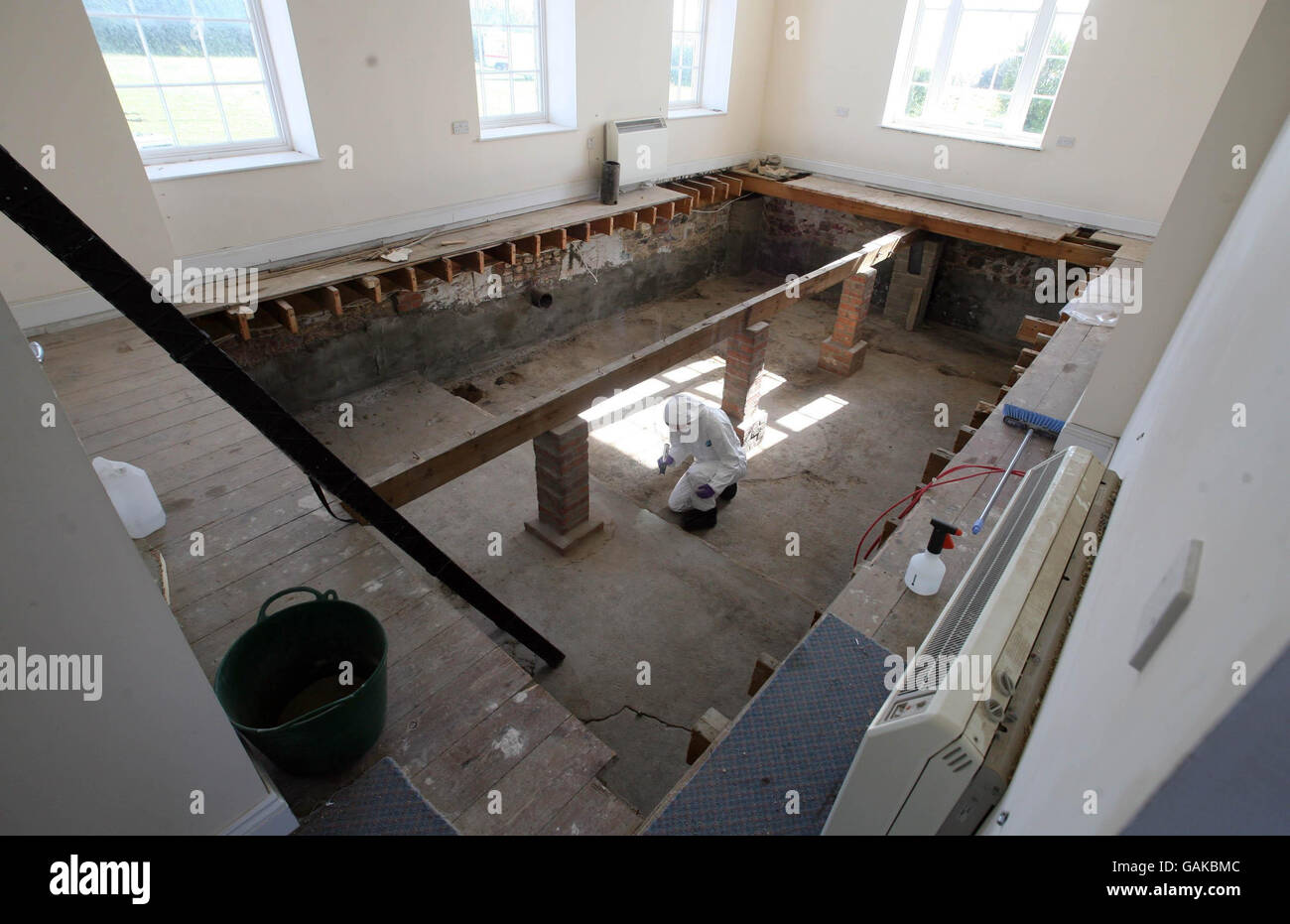 A forensic officer examines the second cellar at Haut De La Garenne, the former children's home on Jersey. Stock Photo