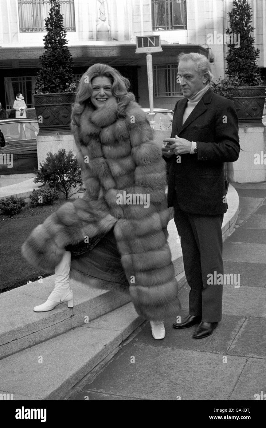 Greek actress Melina Mercouri wears a long fur coat as, with her husband, Jules Dassin, she enjoys the Spring sunshune in Park Lane. Stock Photo