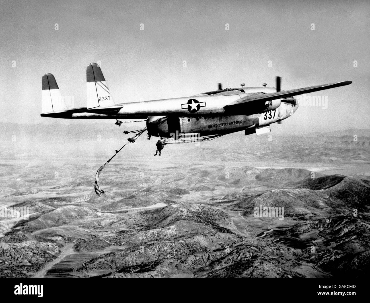 Flying over hills somewhere in Korea, this US Far East Air Forces C-119 Packet aircraft dropped troops and equipment. The aircraft no.337 of the 315th Air Division (Combat Cargo) was one of the many used in a giant air-drop north-wesr of Seoul to cut off the communist troops as they retreated into North Korea. Stock Photo