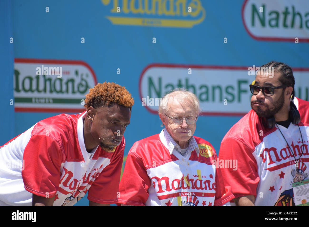 New York City, United States. 04th July, 2016. Seventy-two year old contestant Rich 'The Locust' LeFevre competes surrounded by Juan Rodriguez & Erik 'The Red' Denmark. Eight time Nathan's Famous Fourth of July Hot Dog eating contest winner Joey Chestnut regained the crown he lost last year to Matt Stonie by defeating Stonie eating 70 hot dogs & buns during Nathan's Famous centennial contest in Coney Island. Credit:  Andy Katz/Pacific Press/Alamy Live News Stock Photo