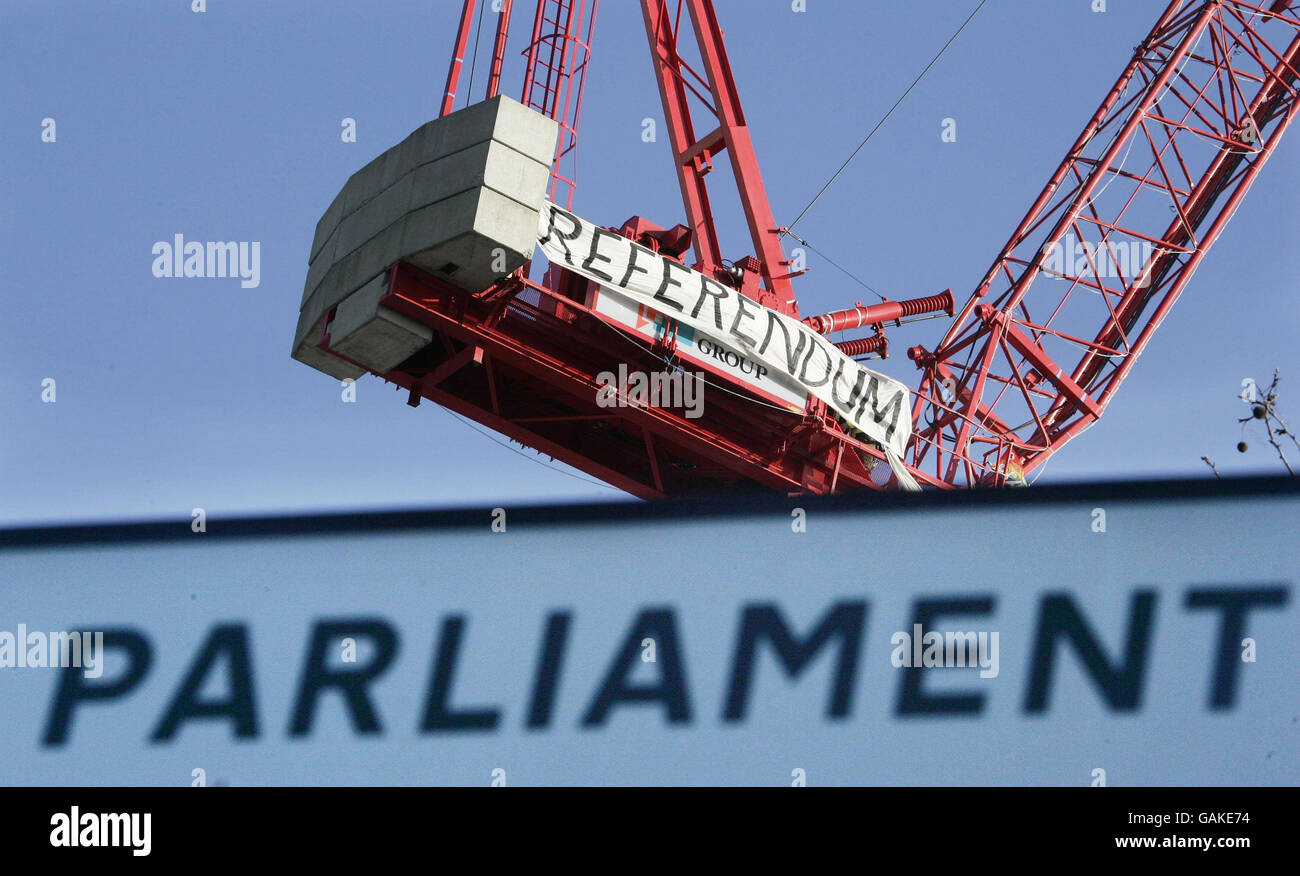 A banner unfurled by demonstrator on top of a crane in Parliament Square, London, in an apparent protest over the EU Treaty. Stock Photo