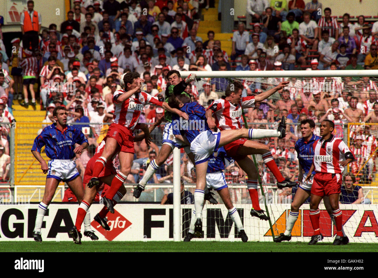 Neil Edwards, Stockport County's goalkeeper, punches the ball away as