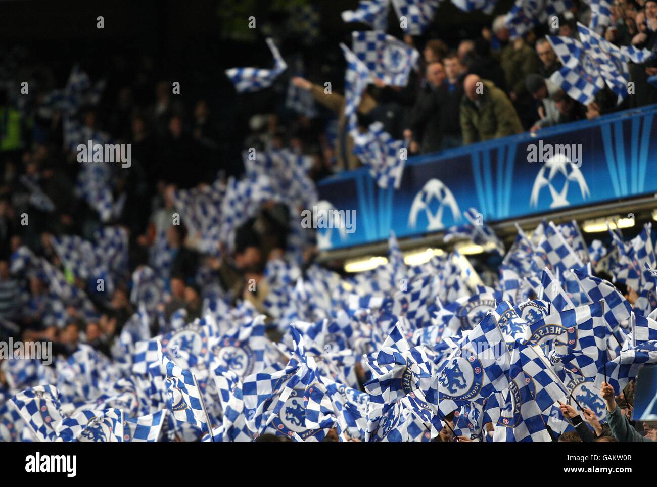 Stamford bridge chelsea fans wave flags in the stands hi-res stock