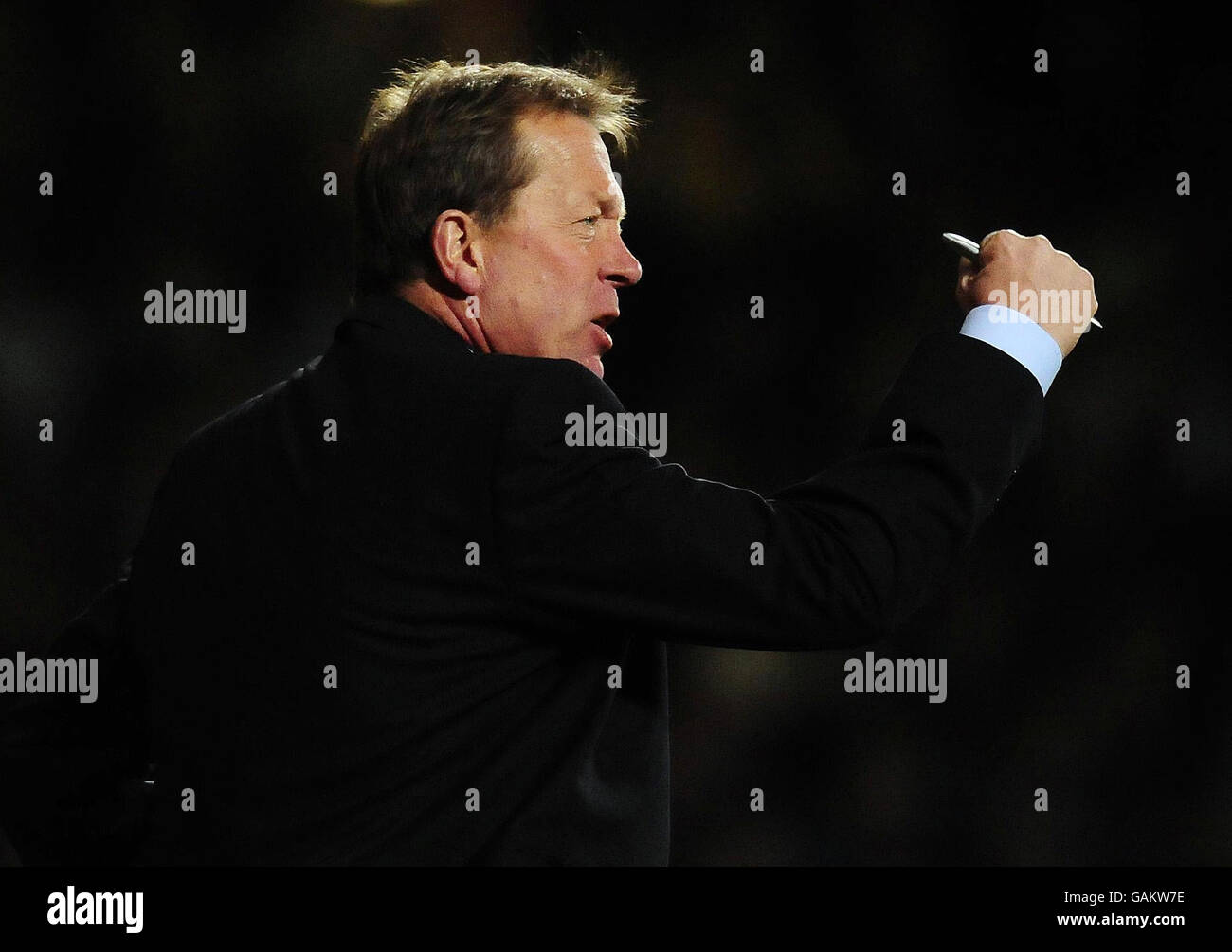 Soccer - Barclays Premier League - West Ham United v Portsmouth - Upton Park. West Ham manager Alan Curbishley encourages his team during the Barclays Premier League match at Upton Park, London. Stock Photo