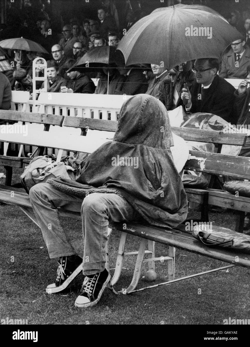 An England fan finds a novel way of keeping dry during the rainstorm that made play impossible for much of the day. Stock Photo