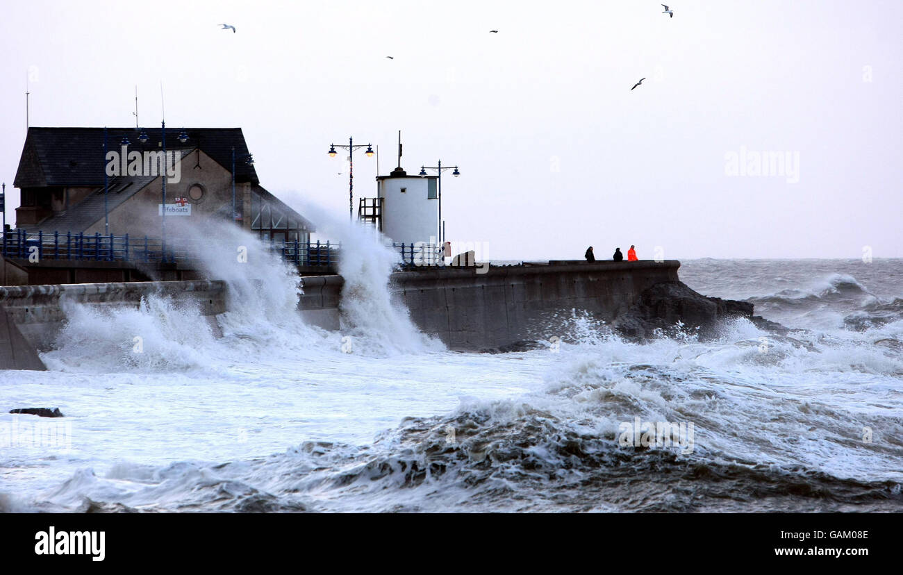 Waves lash the seafront at Porthcawl, Wales, before high tide. Stock Photo