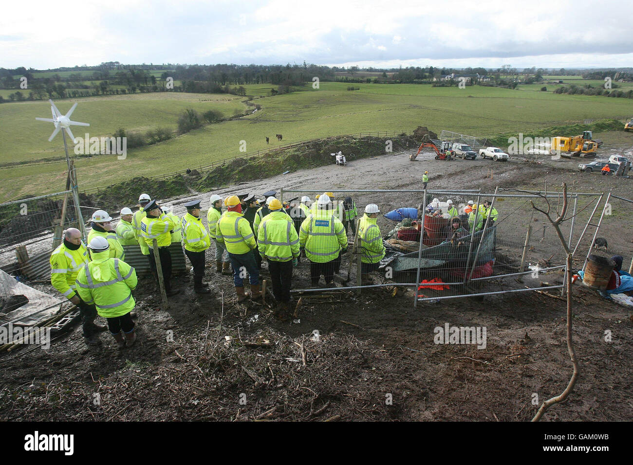 Security workers watch over protesters chained to a barrel at the M3 Motorway site at Rath Lugh in Co Meath. Stock Photo