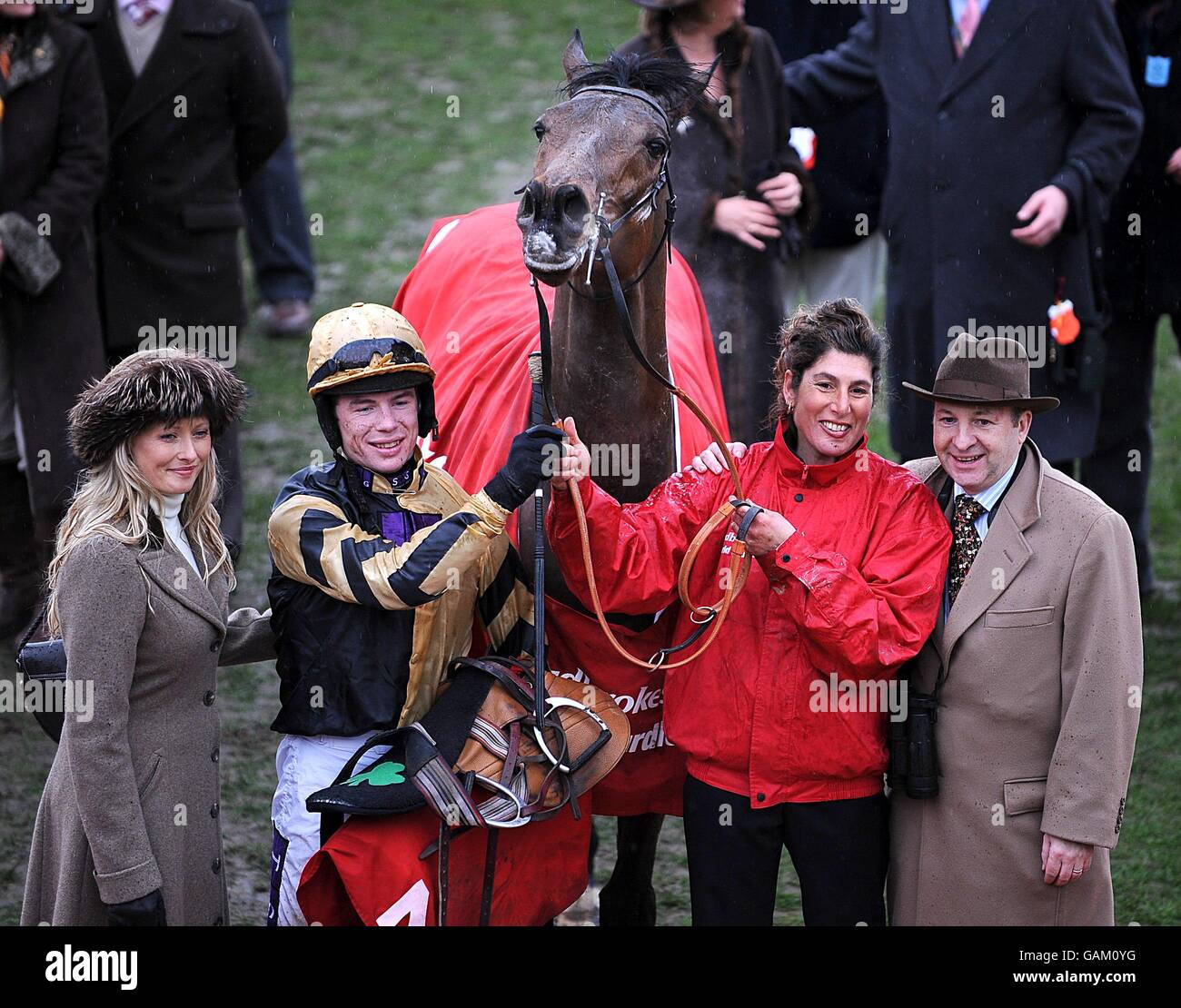 Jockey Denis O'Regan (second left) and owners Andrea (l) and Graham (r ...