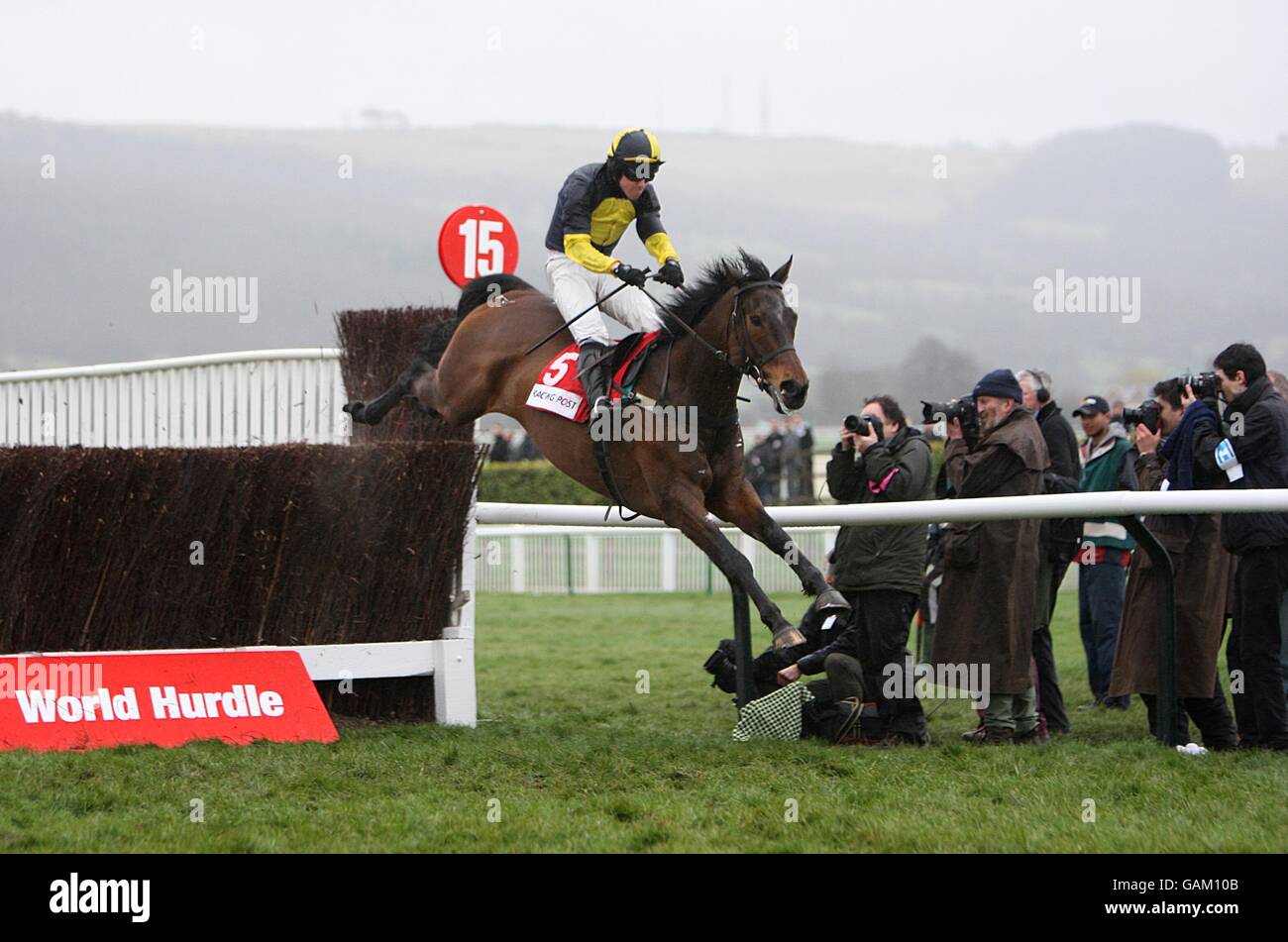 Jockey David Elsworth on Mister McGoldrick safely jumps the last fence to go on and win the Racing Post Plate Handicap Chase during the Cheltenham Festival Stock Photo