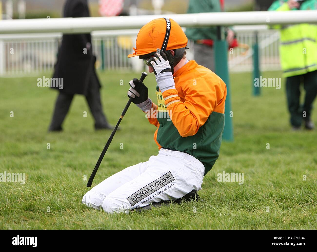 Jockey Thomas Greenall looks dejected after his horse, In Accord, fell in the Peter O'Sullevan National Hunt Chase Challenge Cup during the Cheltenham Festival. Stock Photo