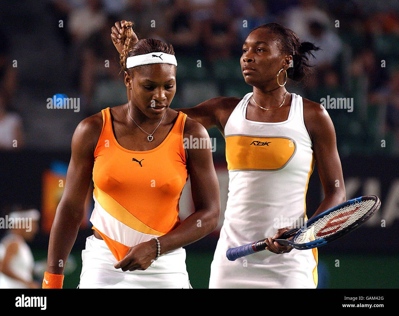 Tennis - Australian Open - Day Twelve.. Venus Williams ties up Serena's hair during their Womens Doubles Final against Virginia Ruano Pascual and Paola Surarez Stock Photo