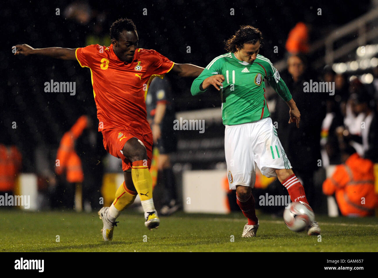 Ghana's Michael Essien (l) and Mexico's Andres Guardado battle for the ball Stock Photo