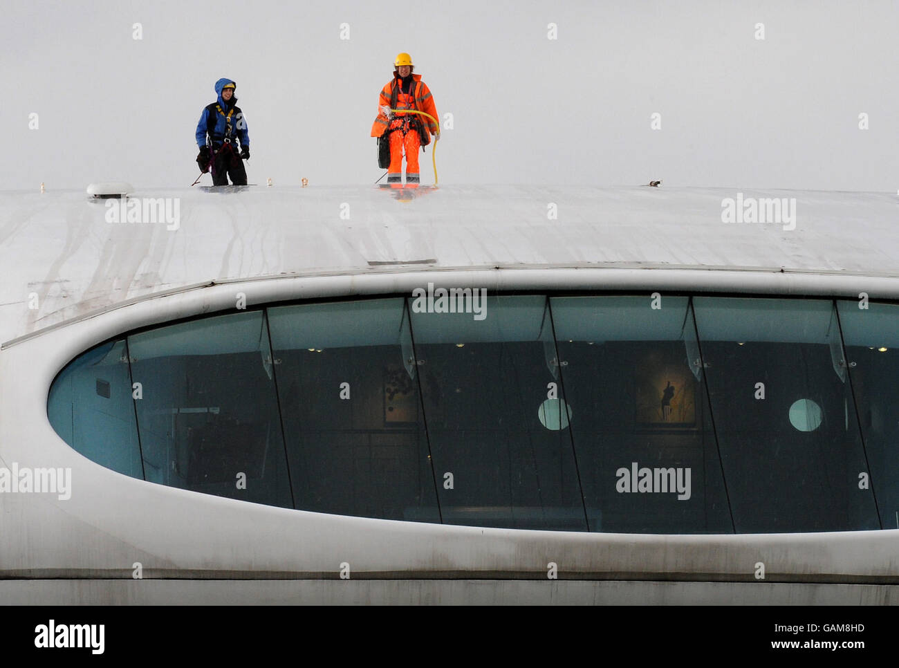 Workers clean the roof of the Media Centre as the England and Wales Cricket Board (ECB) hold the launch of the domestic cricket season at Lord's Cricket Ground, London. Stock Photo