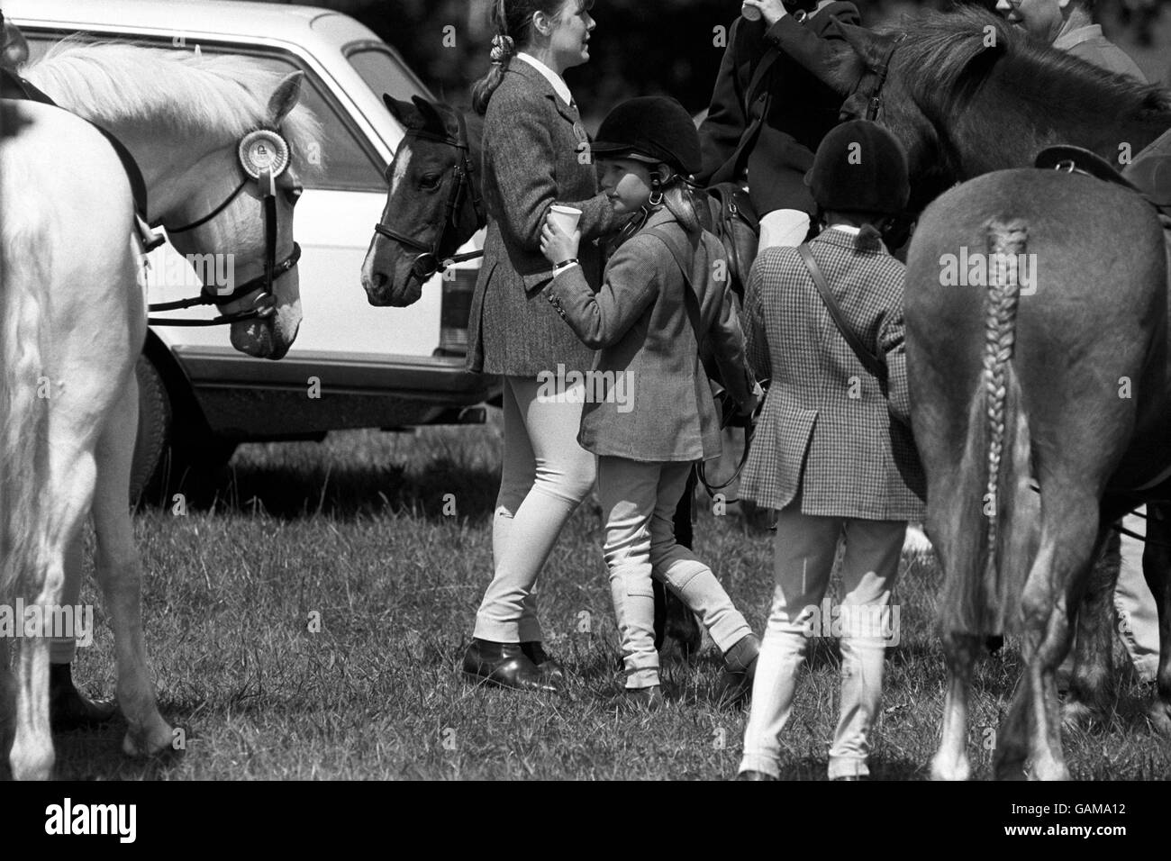 Young Royal Zara Phillips a cooling cola drink at the Windsor Horse Trial. She and her brother Peter Phillips acted as messengers for the judges and organisers. Stock Photo